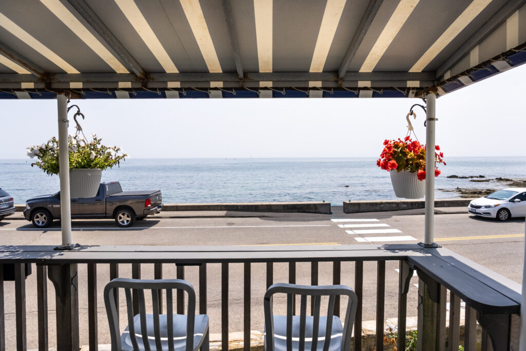 Seating area on porch at Beach House Inn with scenic ocean views